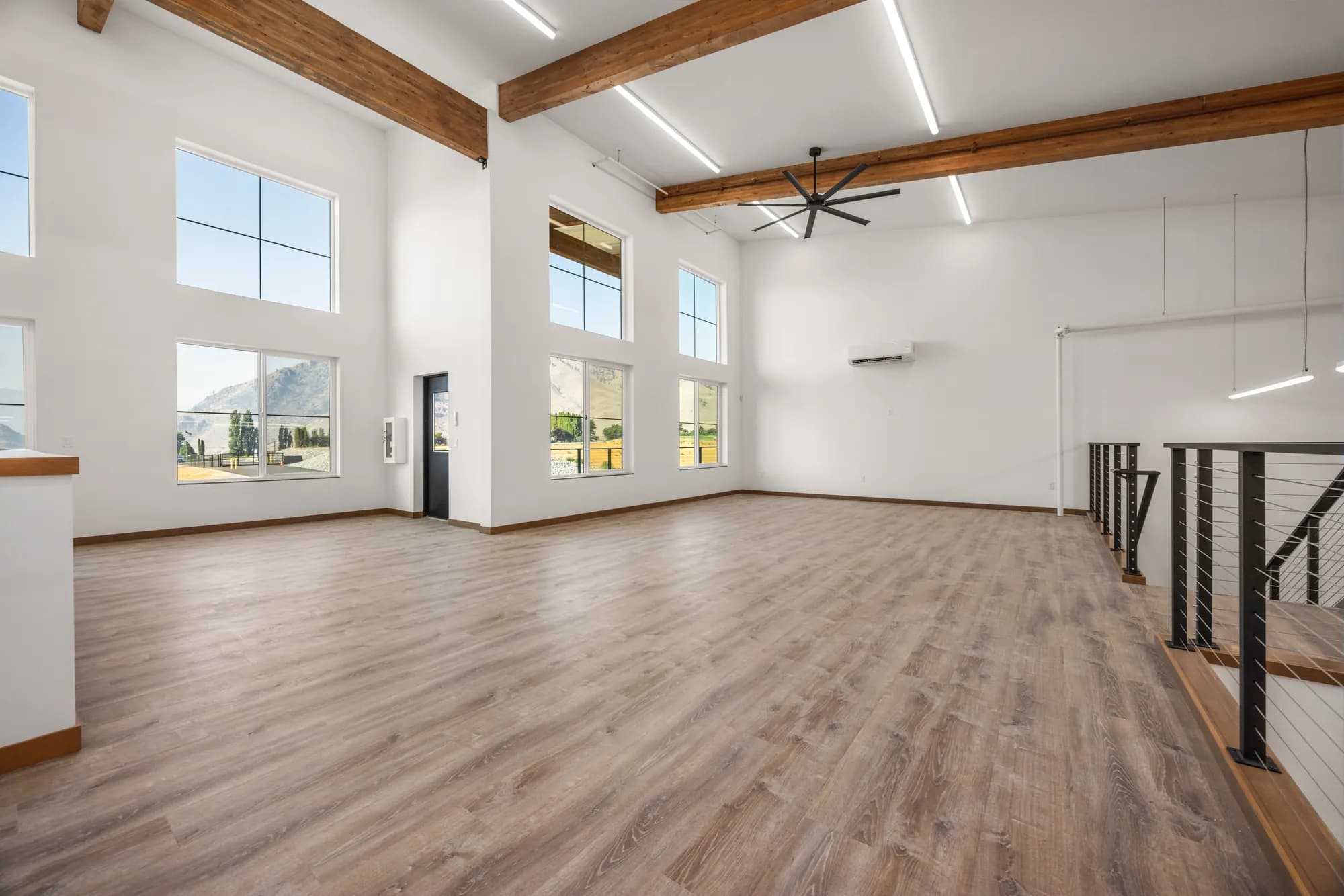 Light-filled clubhouse loft with timber beams and mountain-view windows